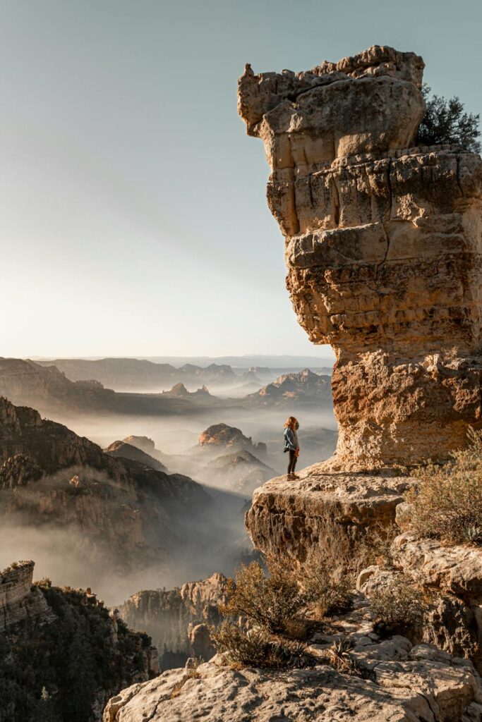 Querying is hard: Woman on a cliff looking up